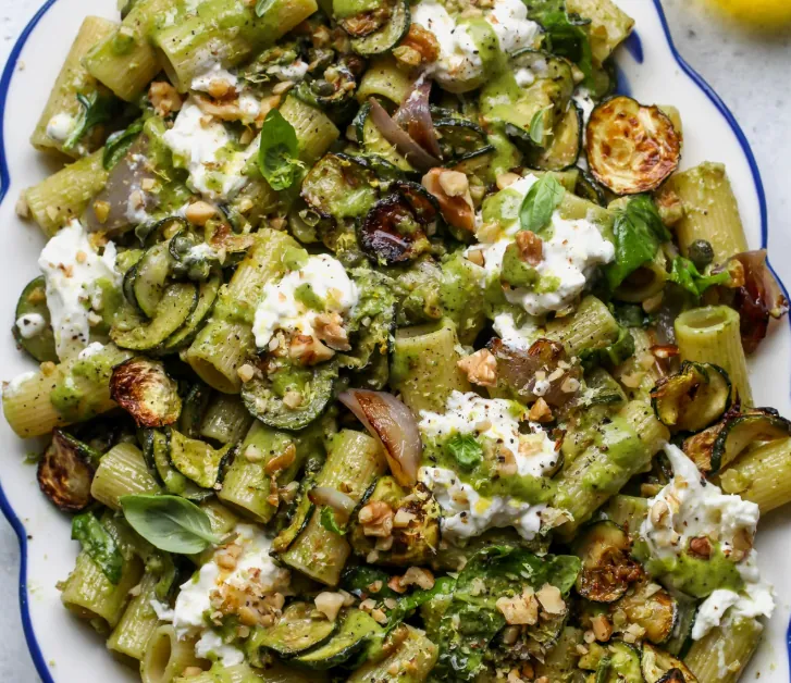 Caramelized zucchini pasta topped with Parmesan, fresh basil, and crispy chickpeas.